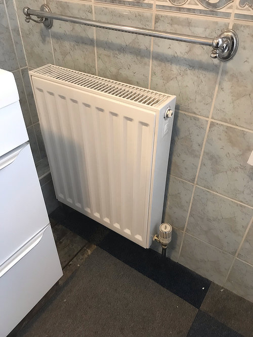 new radiator installed in bathroom